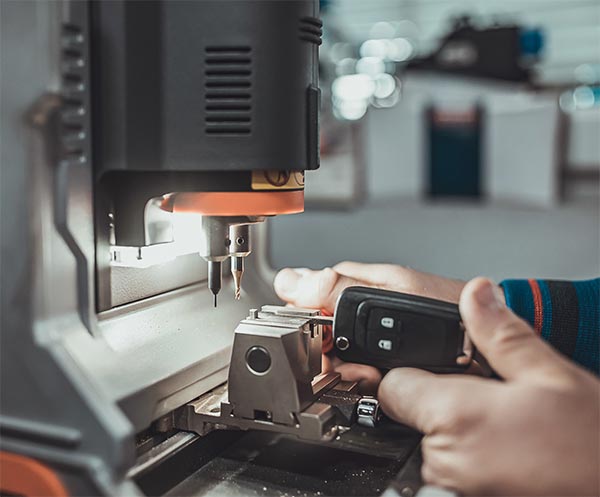 Cutting a replacement car key on a key cutting machine